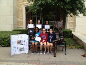 Nitya Rayapati, Renee Johns, Jenna Zhang, Mackenzie Farkus, Kerianne Chen, and Asha Rao (front to back, left to right) showing off their award-winning Yearbook project board.