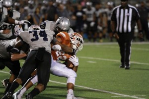 Prince Ugwu '17 powers through a crowd of Hendrickson defenders.