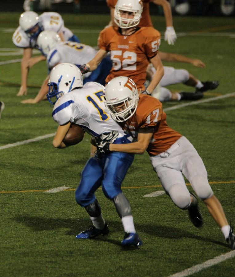 Aaron Gonzoles 18 tackles a Pflugerville offensive player.