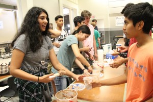 Anjali Venkatesh '17 spoons out ice cream to Rishabh Shah '18.