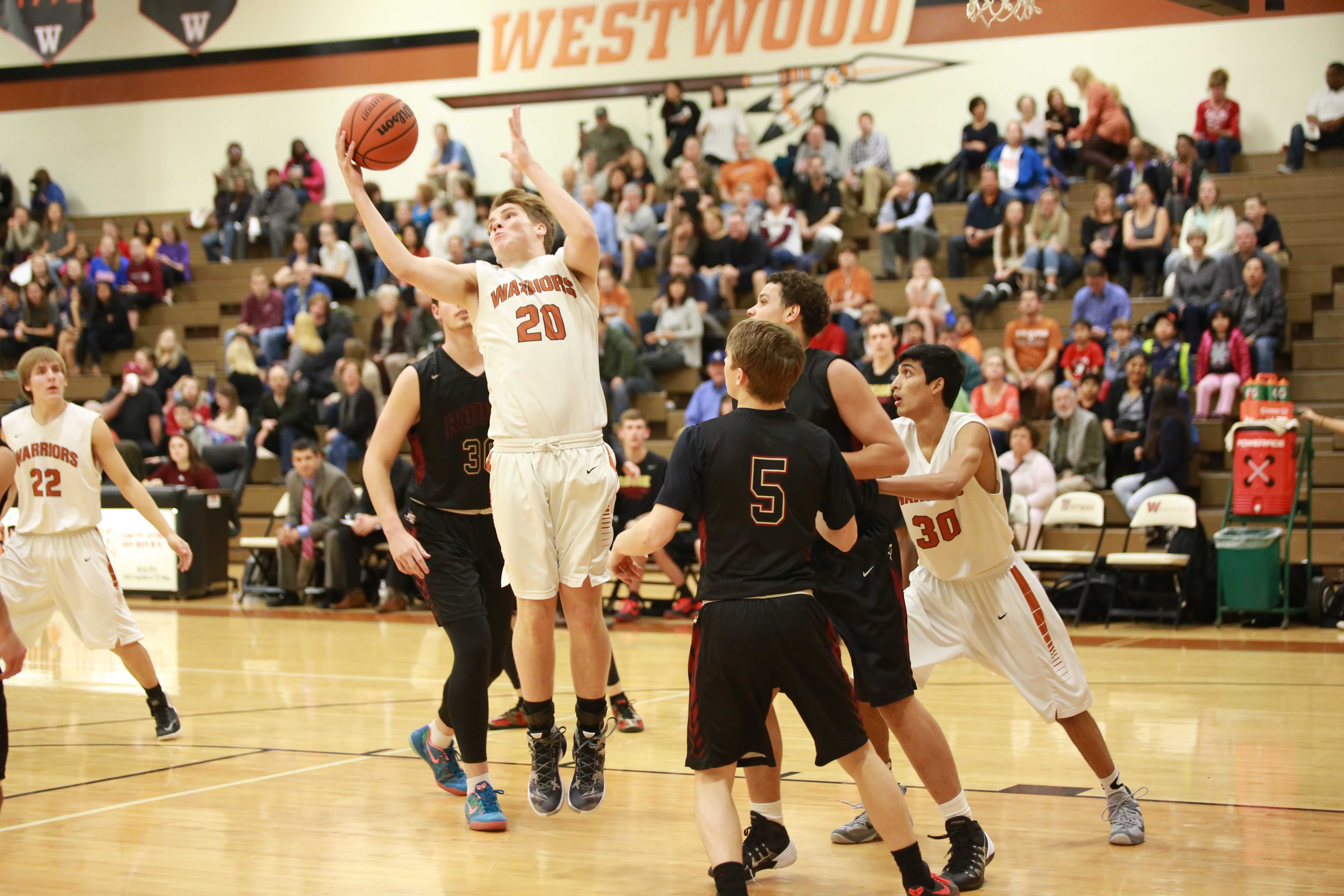 Varsity Boys' Basketball Defeats Rouse Raiders