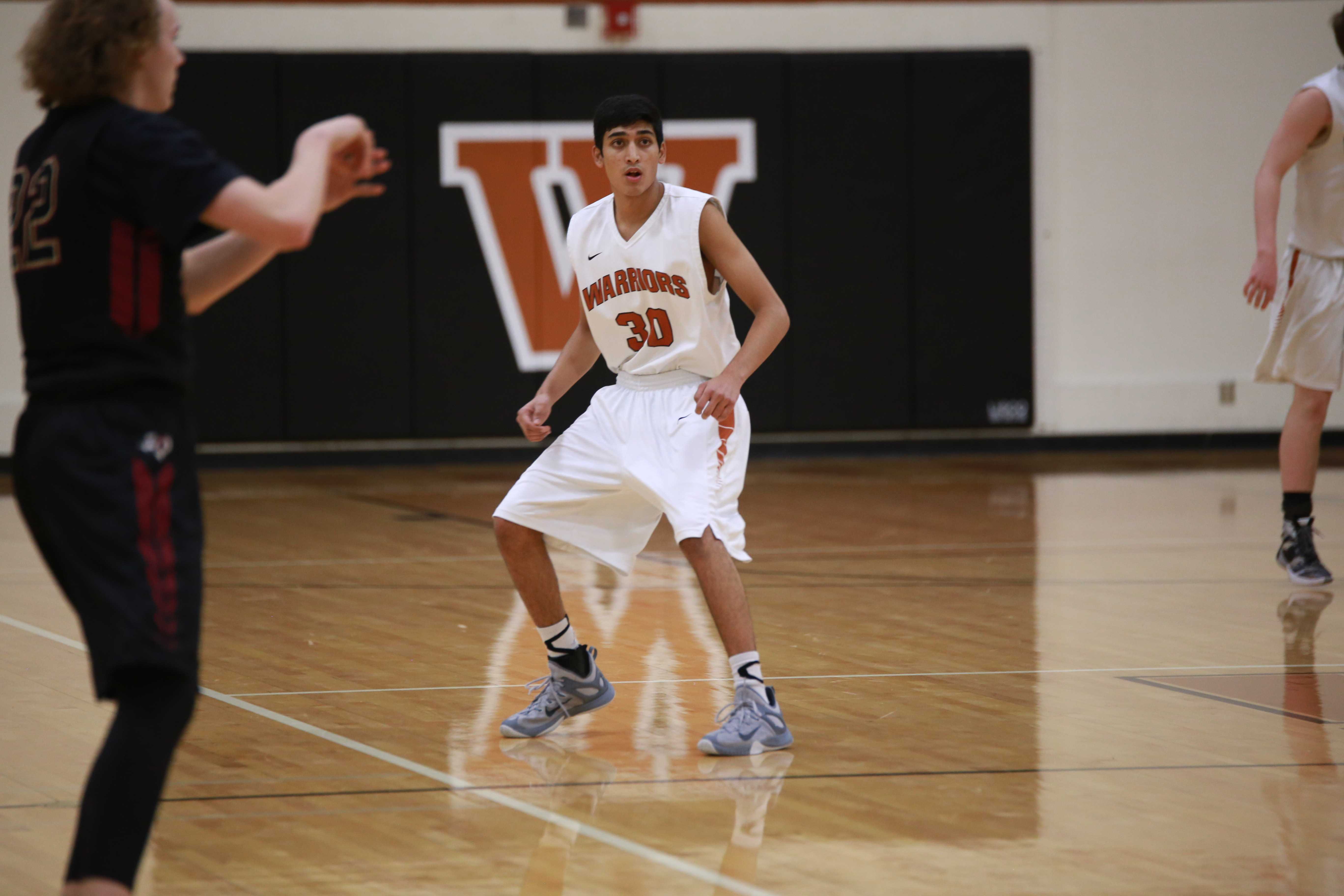 Varsity Boys' Basketball Defeats Rouse Raiders