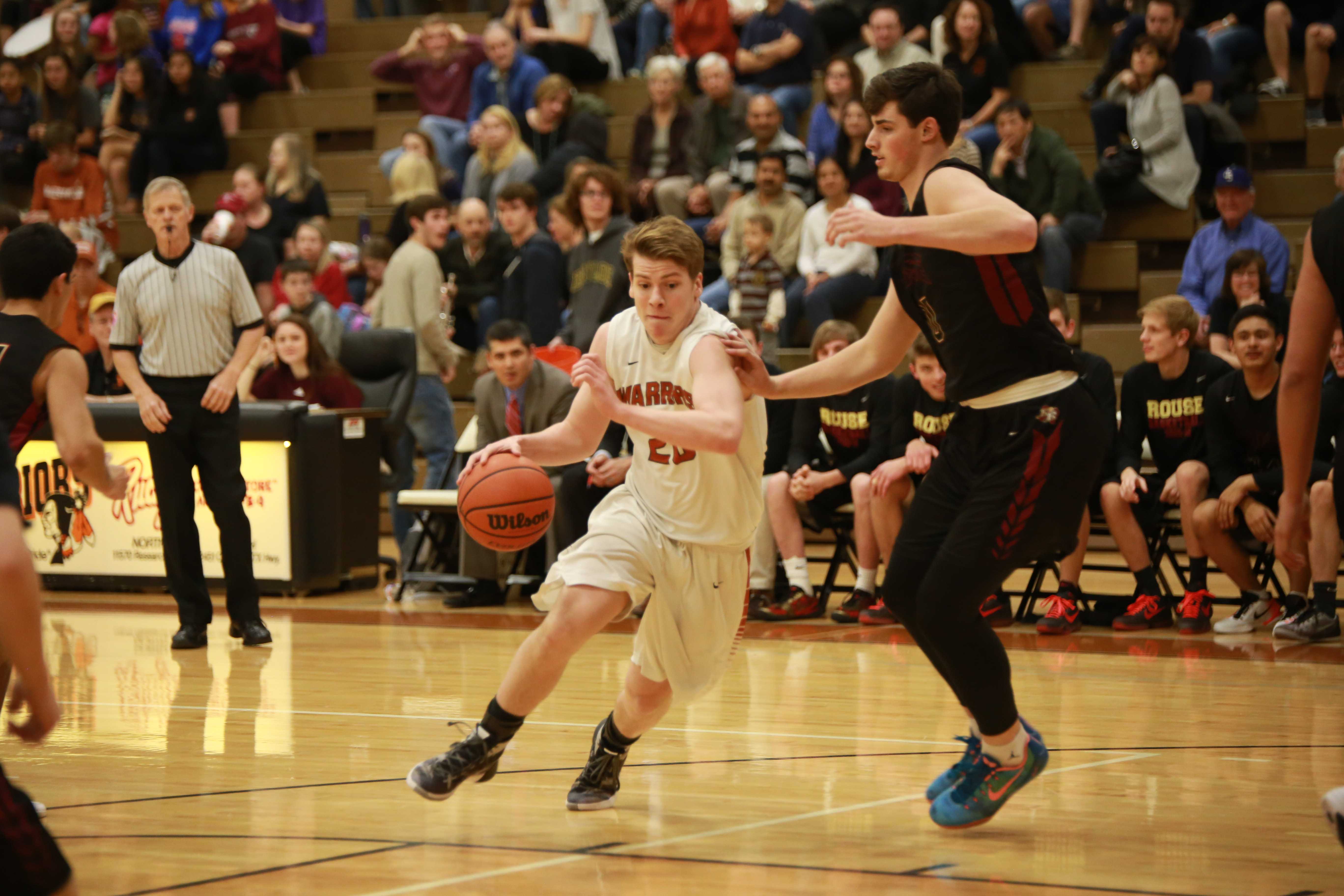 Varsity Boys' Basketball Defeats Rouse Raiders