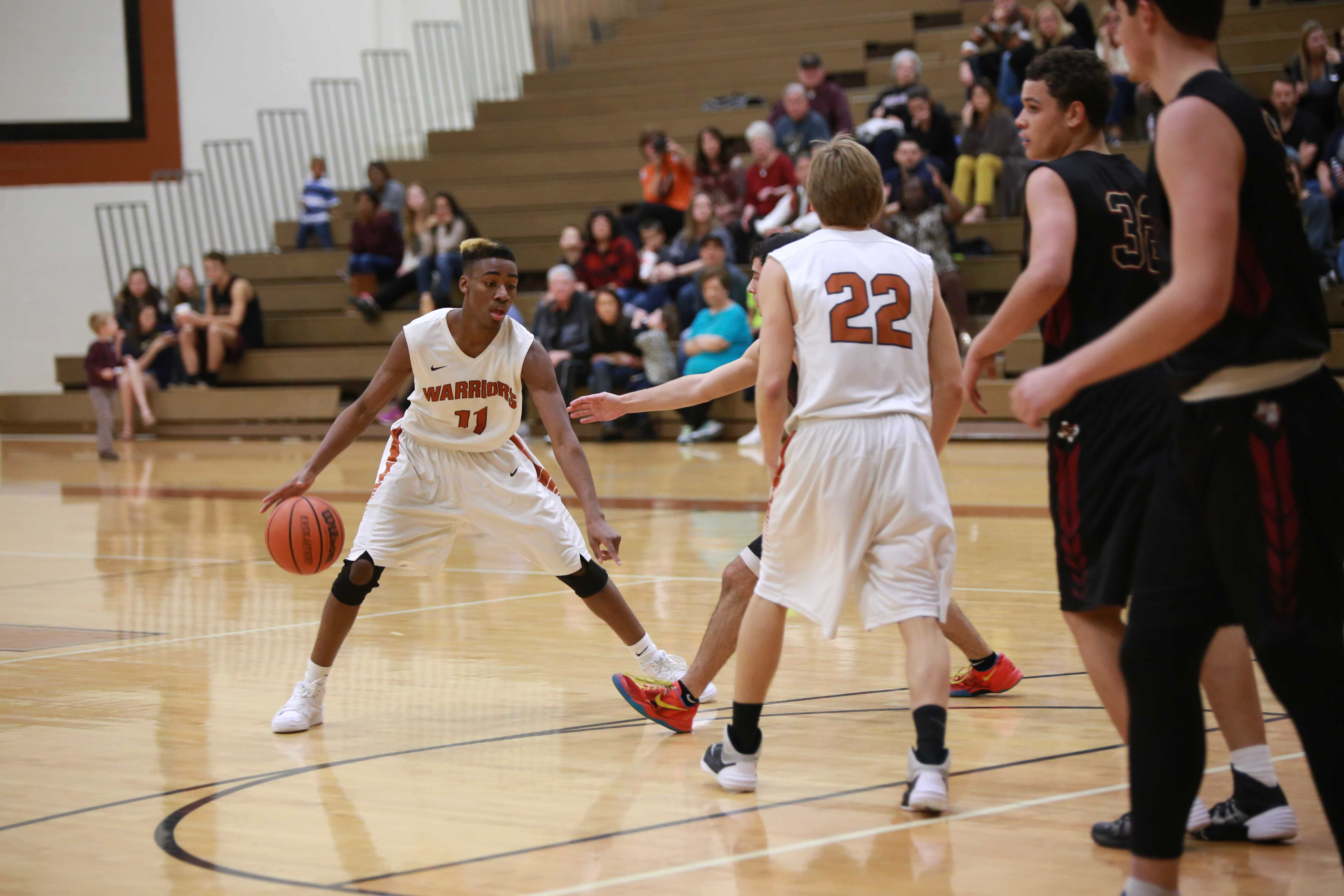 Varsity Boys' Basketball Defeats Rouse Raiders