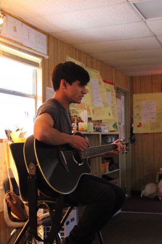 Doug D'Lacoste '17 brings out his guitar and sings Ed Sheeran for his poetry project.