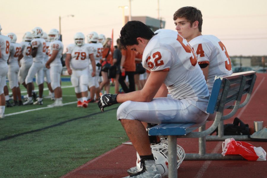 William Wallace 18 and Marley Schiesz 18 take a seat after they run off the field.