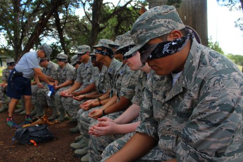 Cadets play a game where they are blindfolded and must figure out what color shapes each member and leader have.