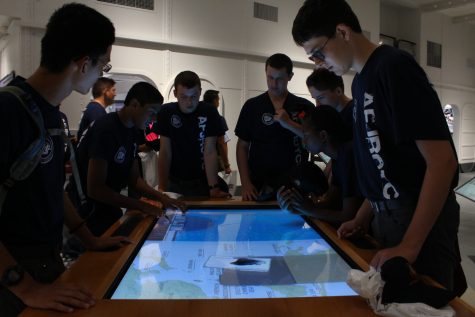 Cadets play with an interactive boat and map simulator at the National Museum of Pacific War.