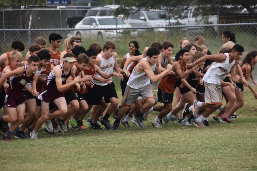 The varsity team pushes through their competition to get a starting lead in the race.