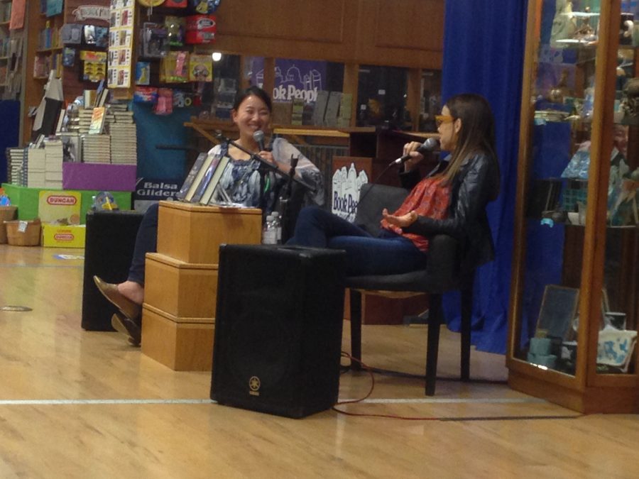 Ms. Marie Lu and Ms. Margaret Stohl conduct a conversation to answer pre-written audience questions for the speaking event. 