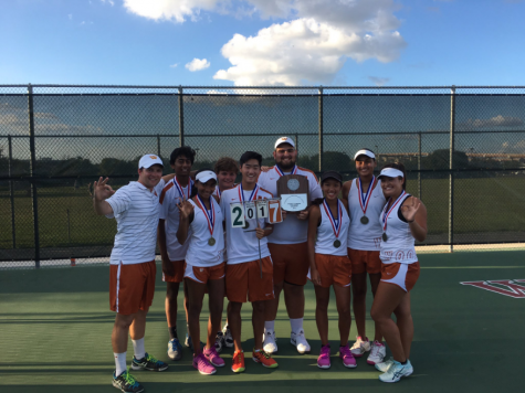 The seniors of the team show off their last district plaque.