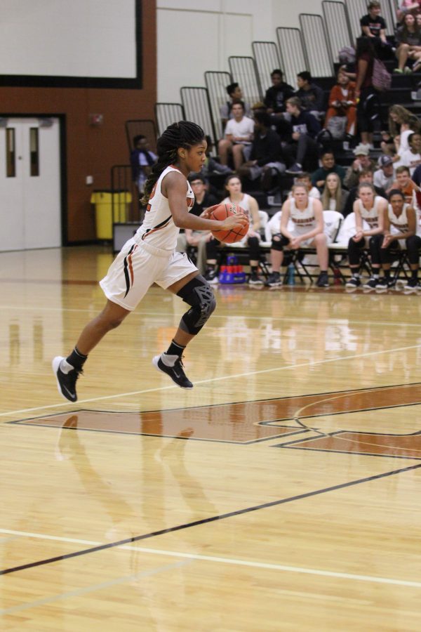 Allyah Beaty 18 drives down the court in the third quarter. 