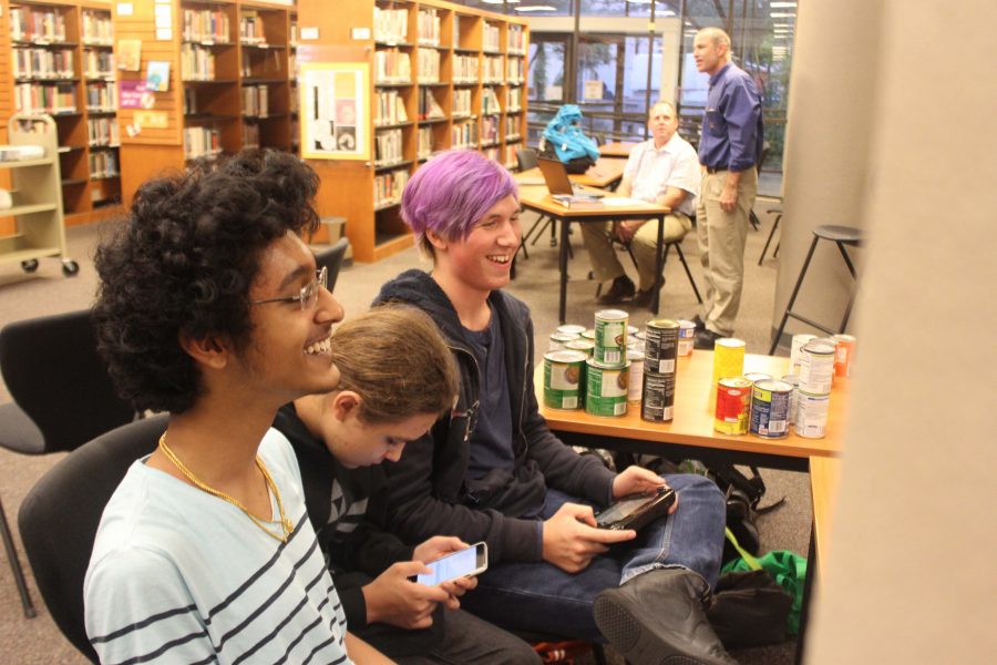Athreya Vadayar 20 (left) and Xavier Berens 20 (right) play a friendly game of SMASH Bros. while Vincent Reed 20 (middle) texts a friend. 