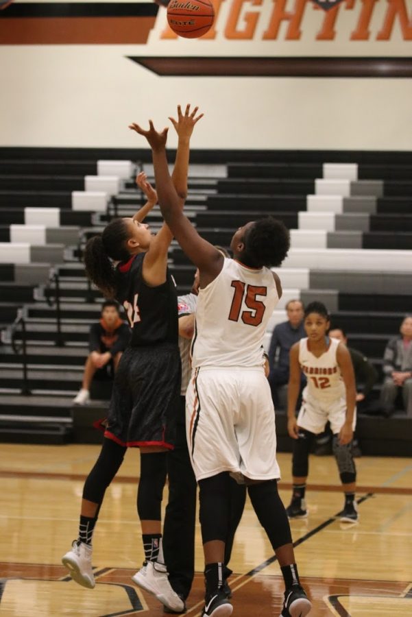 Kandyce Shepard 17 reaches for the ball at tip-off.