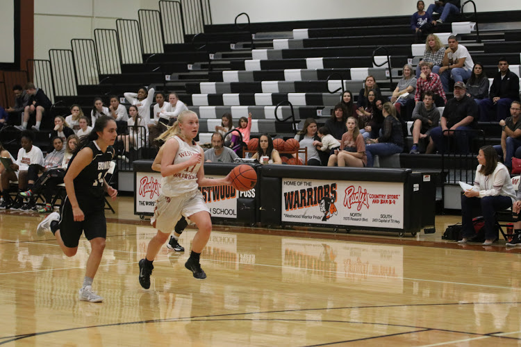 Christy French 17 dribbles the ball to the basket.