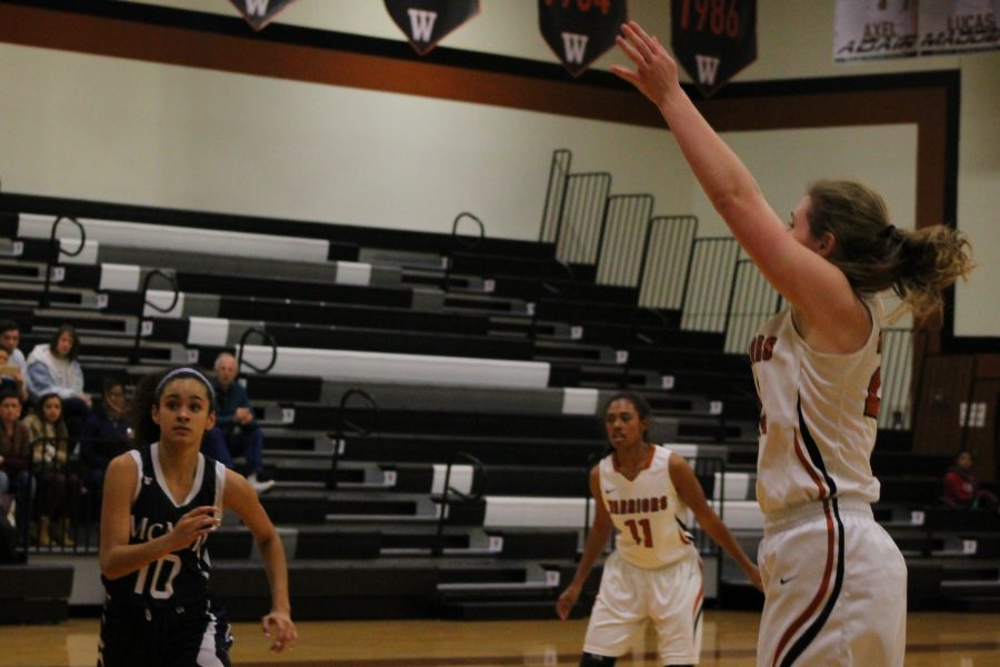 Taking a shot, Madison Couch ‘17 attempts to score points for the Lady Warriors.