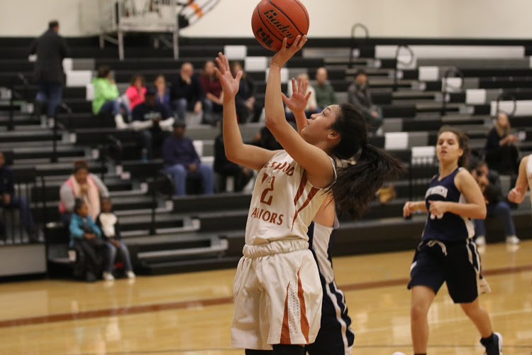 Annalise Galiguez 20 lays the ball into the basket.