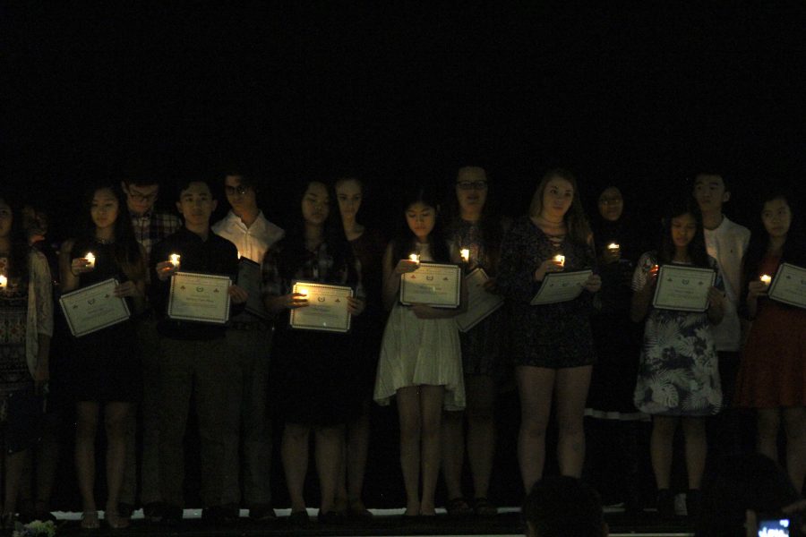 New inductees recite the NFHS pledge on stage.