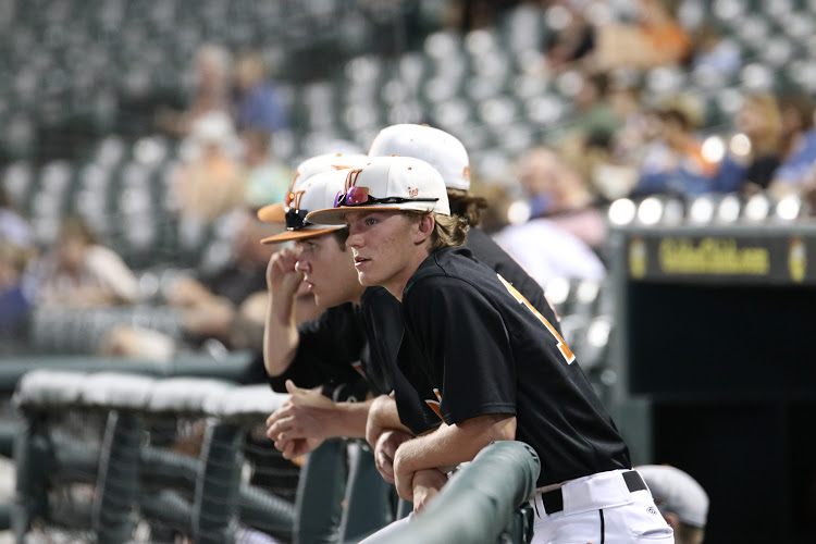Reid Carrier 18 watches his teammates play from the dug out. 