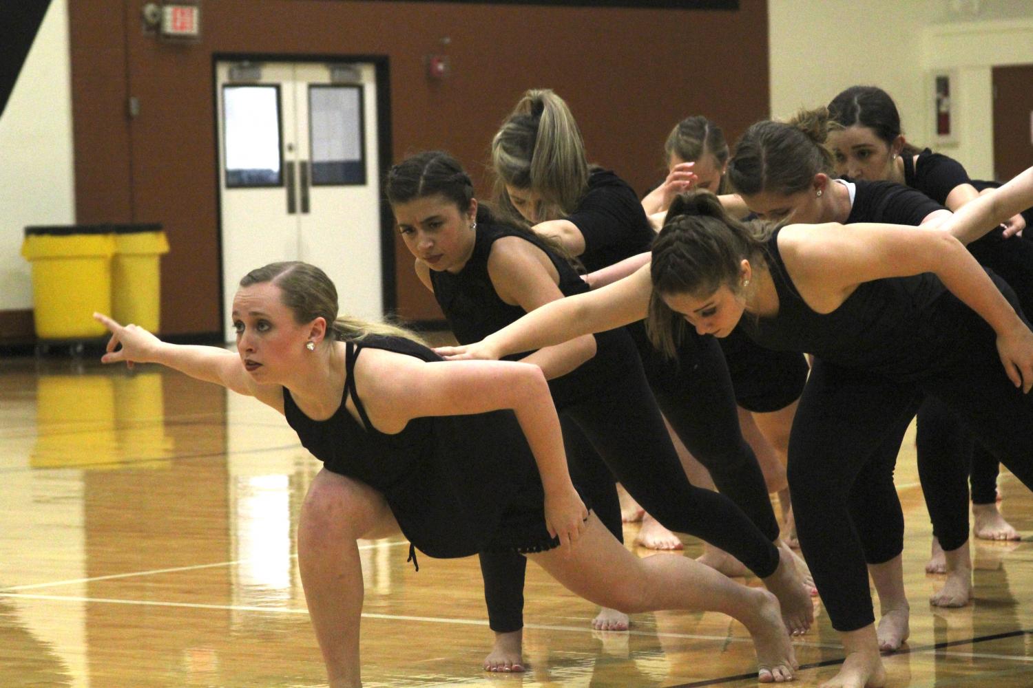 Tori Loper 17 leads a formation in a performance.