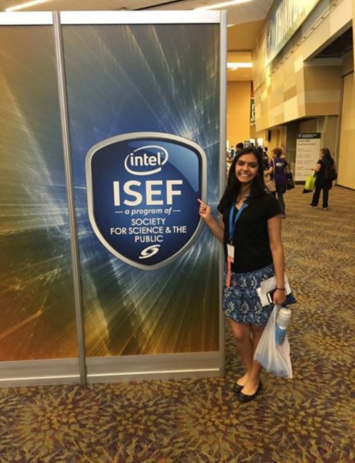Joshi poses in front of an ISEF board in Phoenix 2016.