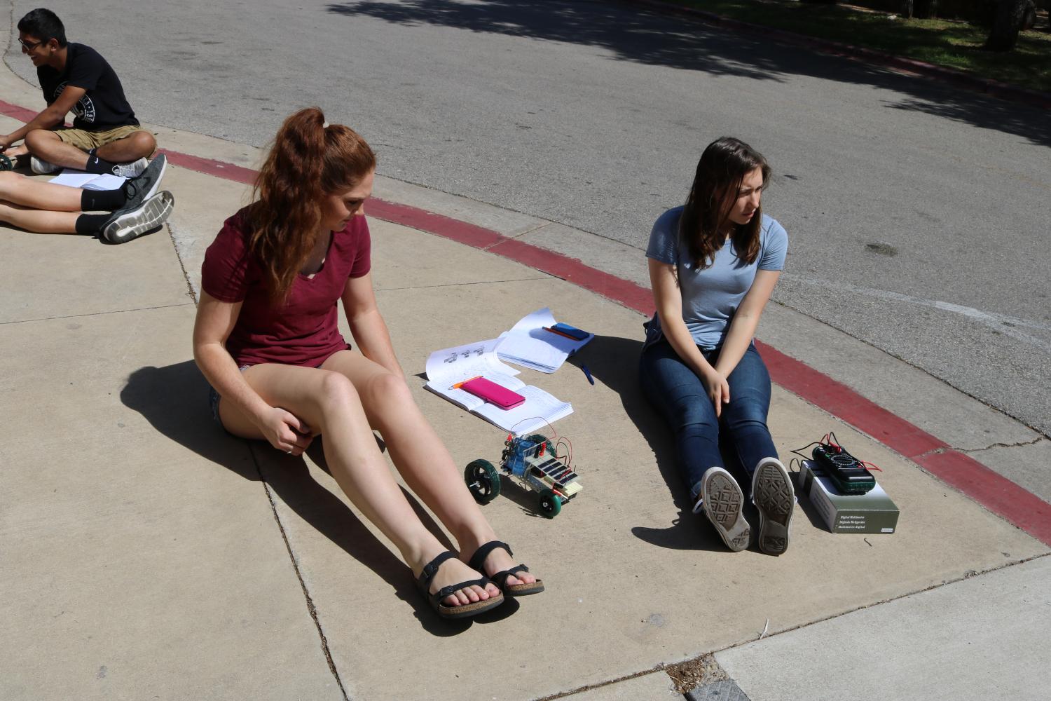 Seanne Bouy 19 and Ashlyn Hill 17 wait for their fuel cell to charge. 
