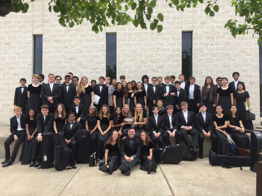 Wind Symphony stands with their trophy after receiving a score of all ones at their UIL contest.