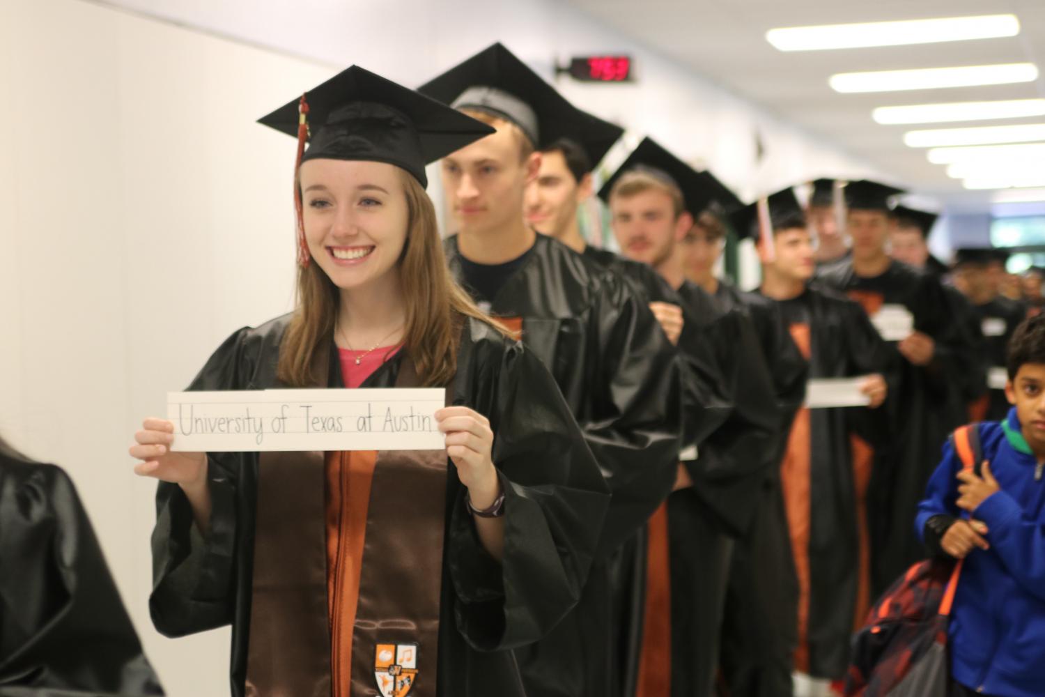 Lauren Price 17 walks through the hallways with her college sign.