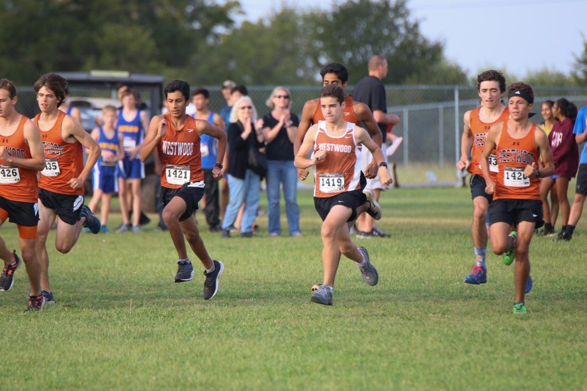 The cross country team begins the race. 