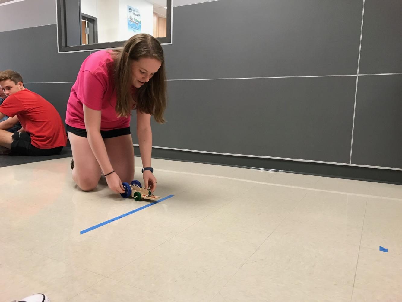 Erika Houser 19 readies her mousetrap car for her test run. 