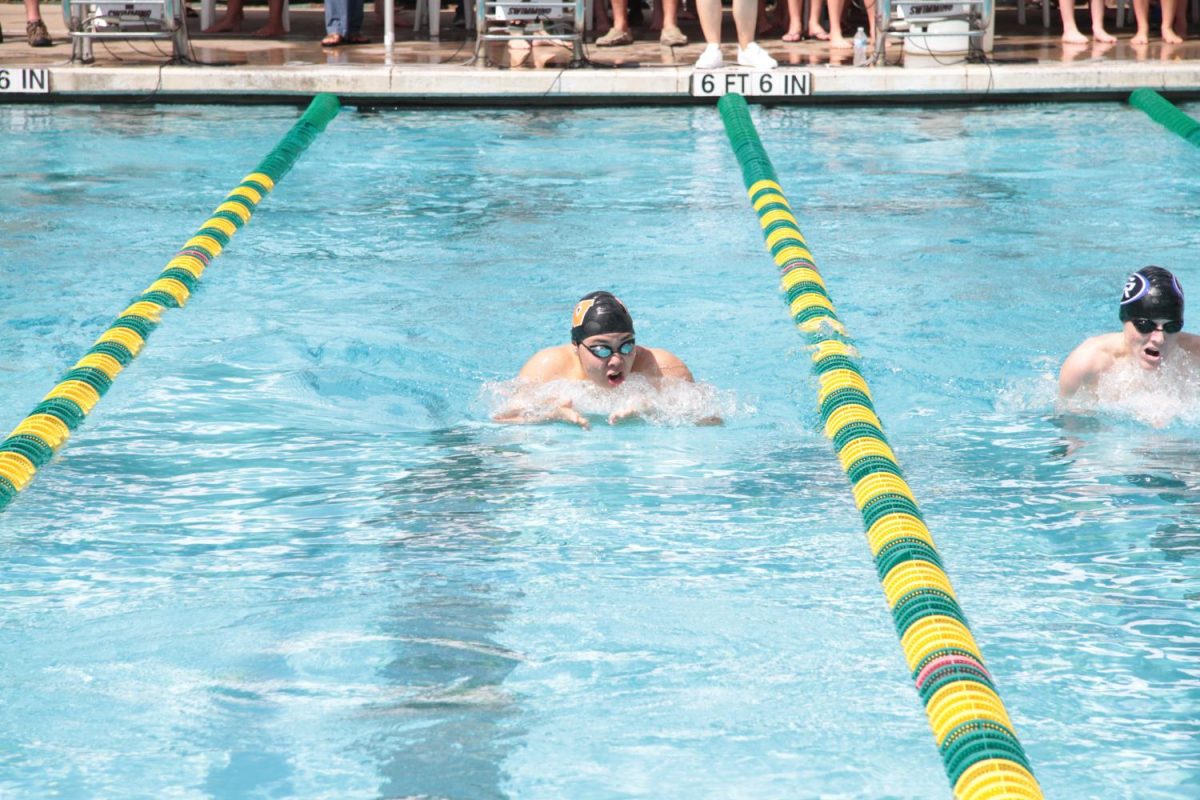 Eric Wang 19 chases down his competitor while doing the breaststroke.