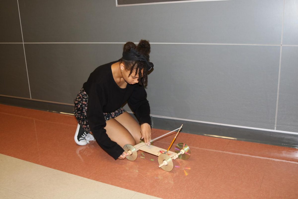 In physics, Ahyana Johnston 19 works on her mouse trap car.