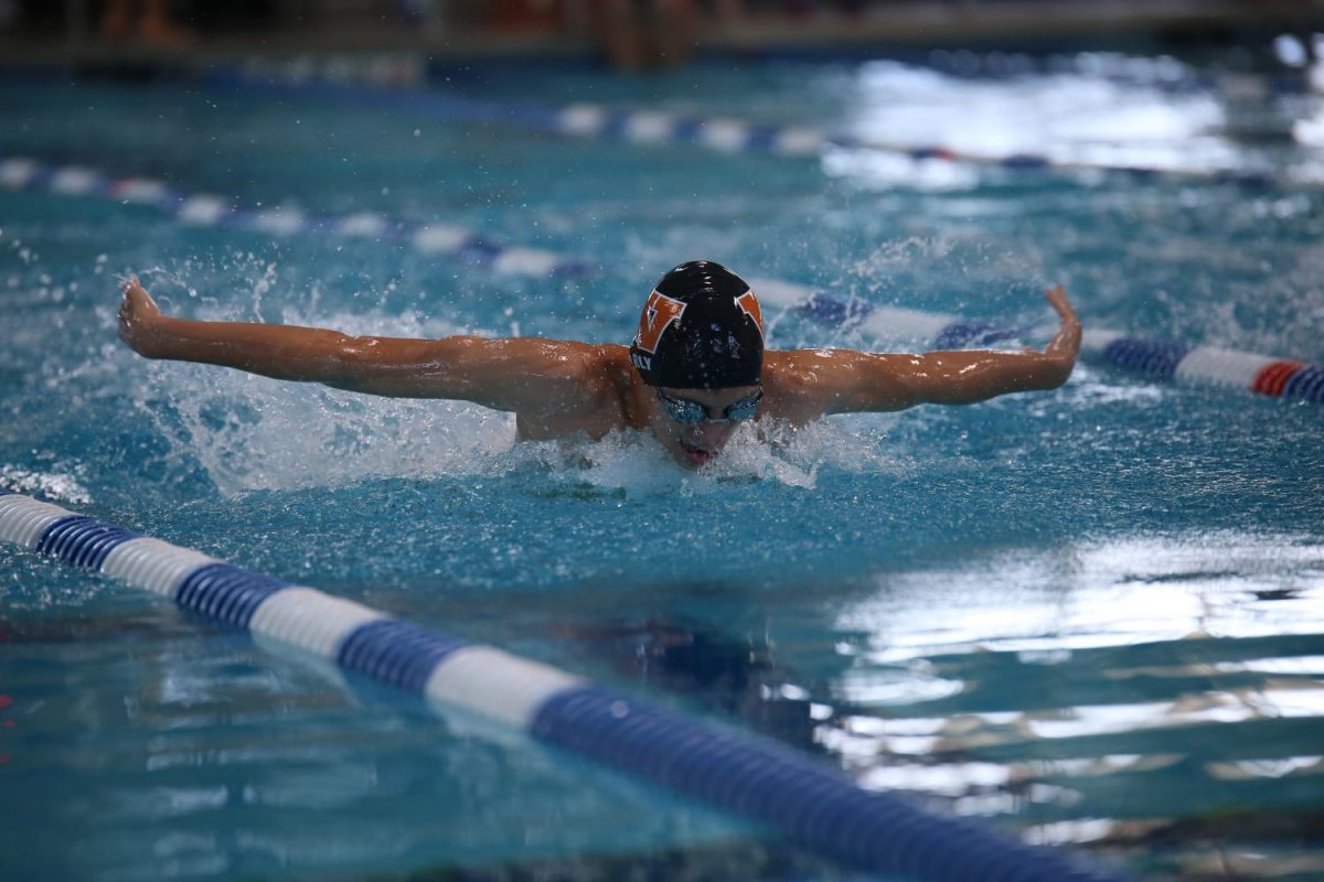 Nathan Early 20 takes a breath during the butterfly portion of the 200 individual medley.