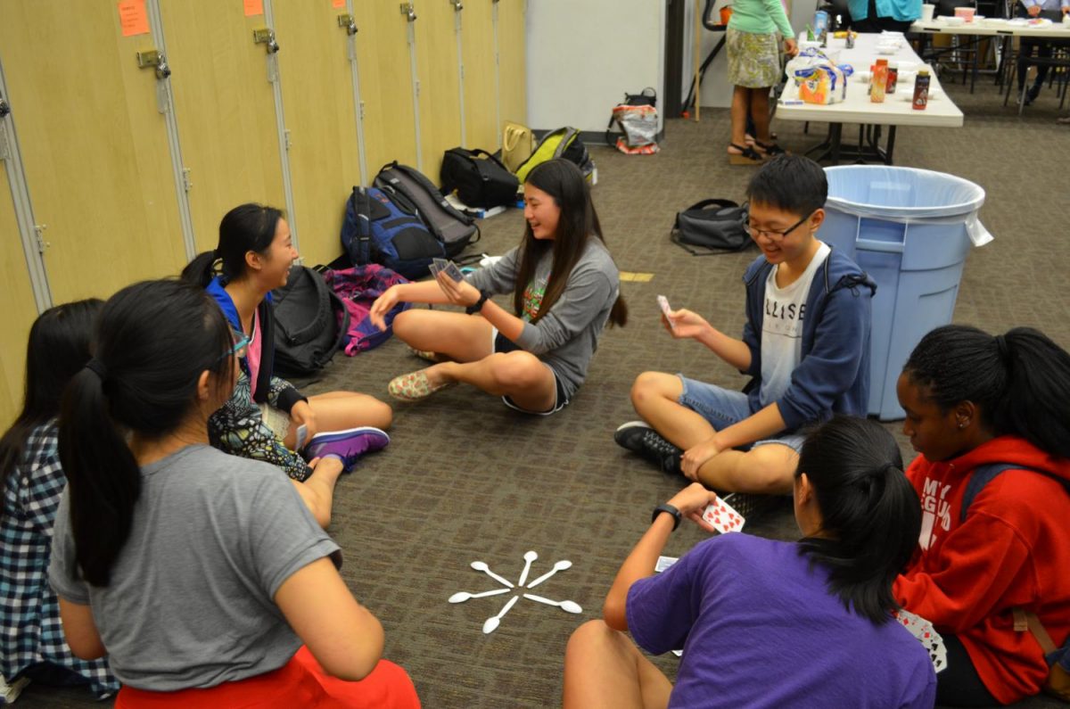 Students play the card game Spoons