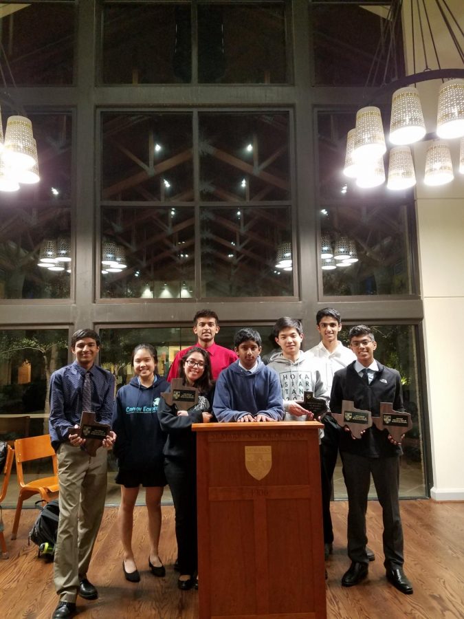 Debate students pose with their awards.