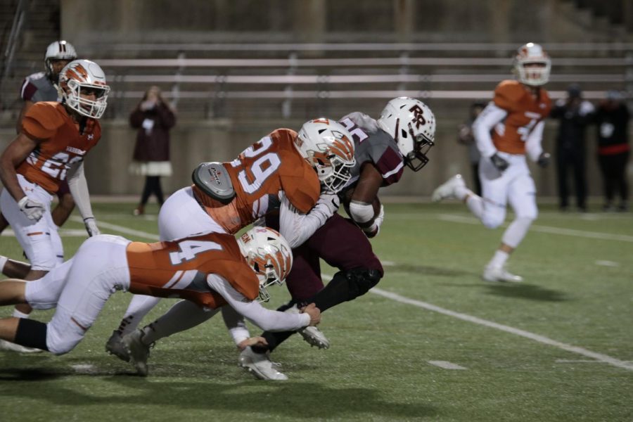 Reed Harrington 18 and Reese Green 18 stop Round Rock with a collaborative tackle