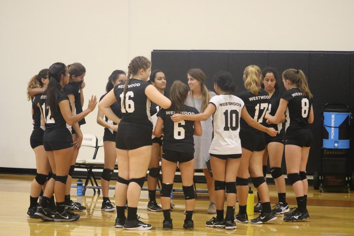 The whole team talks with their coach before securing their win against the lady panthers. 
