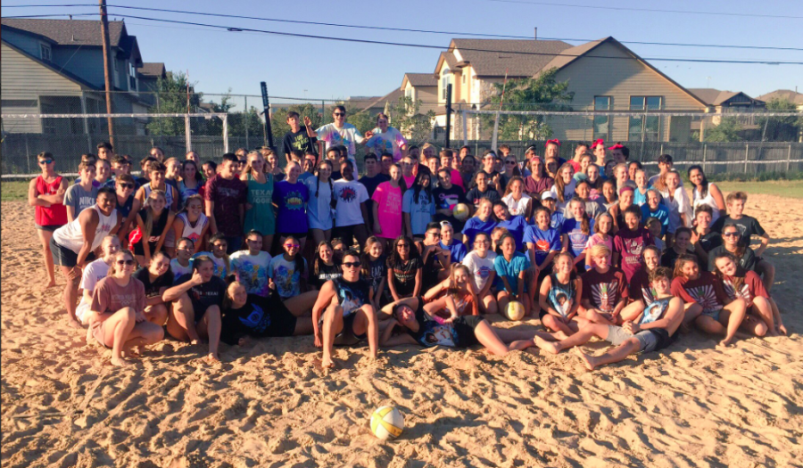 The participants of Spike Fest pose together on the sand courts. Photo credit to Westwood Volleyball.