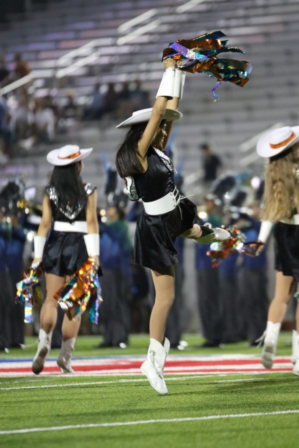 Khira Patel 18 jumps up as she performs during half time at the game.
