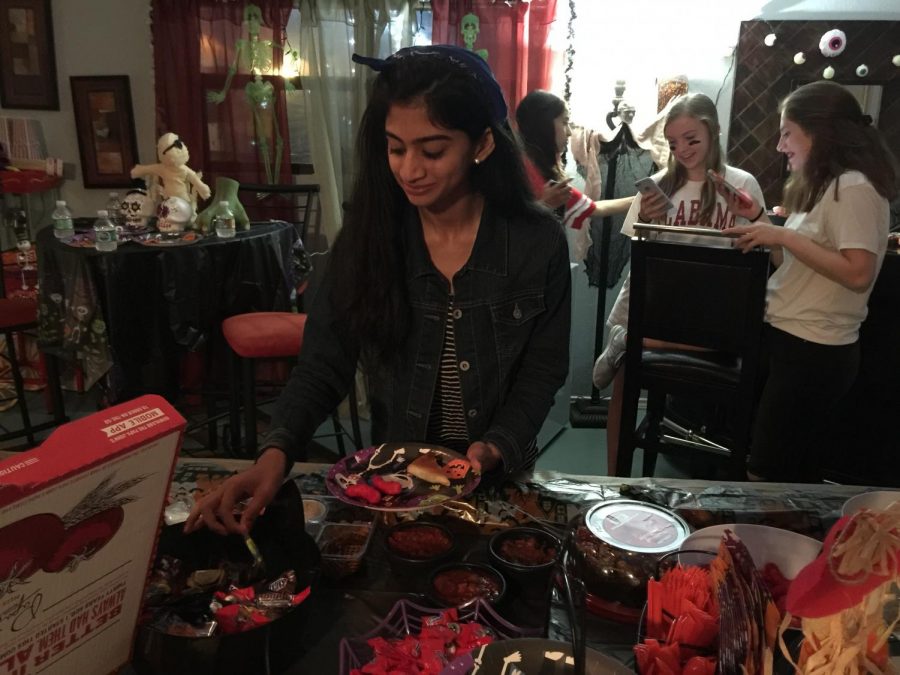 Arooshi Yakanti 19 grabs some candy to eat along with her pizza.