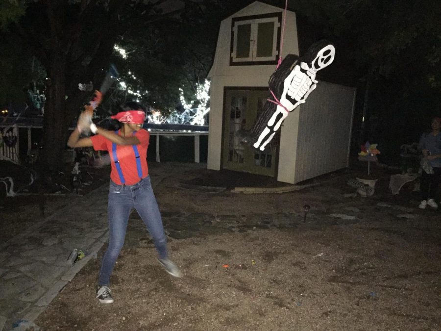Divya Nair 19 takes a swing that the skeleton piñata.