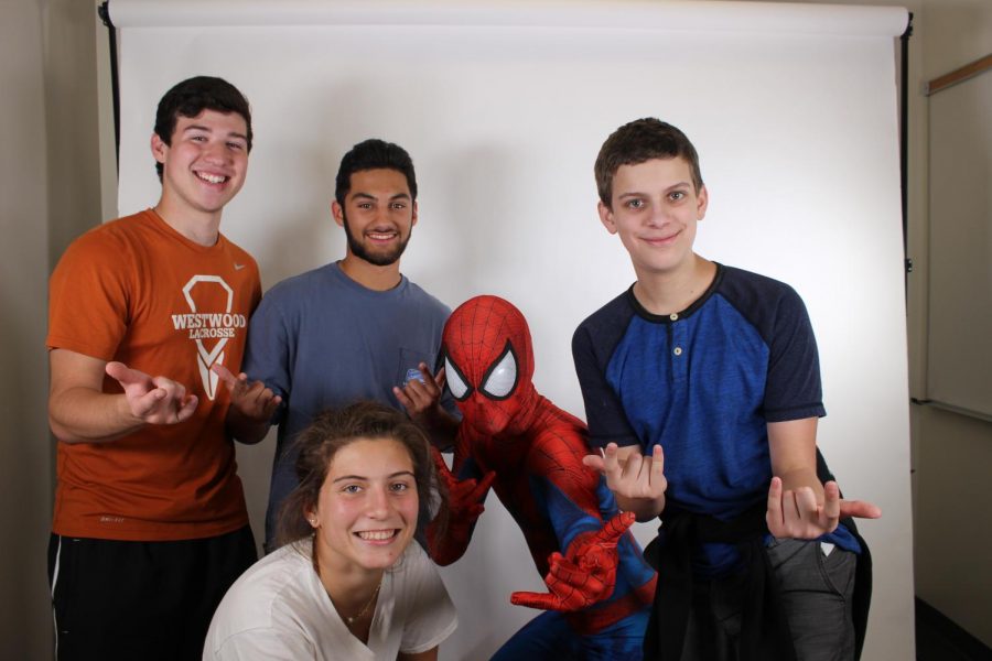 Brandon Lutz 19, Dalton Nandin 19, Noah Barbin 19, and Stephanie Jbeily 19 smile with Spider-Man.
