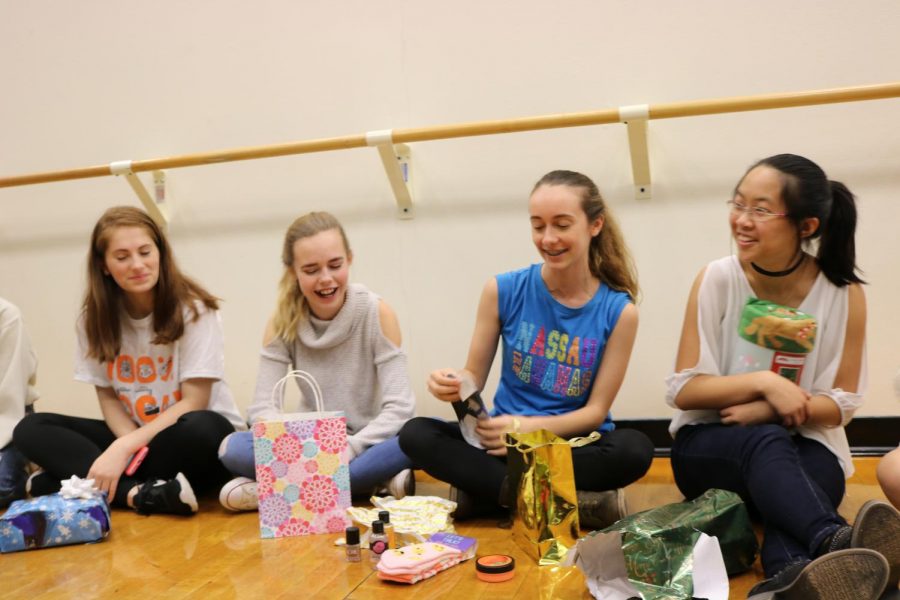 Rachel Rusch 20, Camille Houssay 20, Florie Sambuis 20, and Shannon Chao 20 laugh as Sambuis opens her white elephant gift.