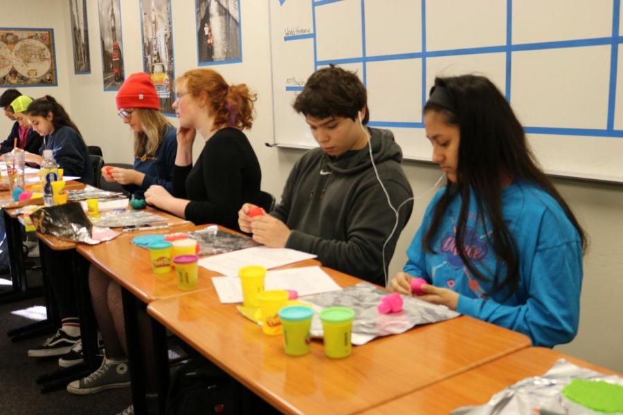 A group of students work on their play doh brains in Ms. Eyobs class.