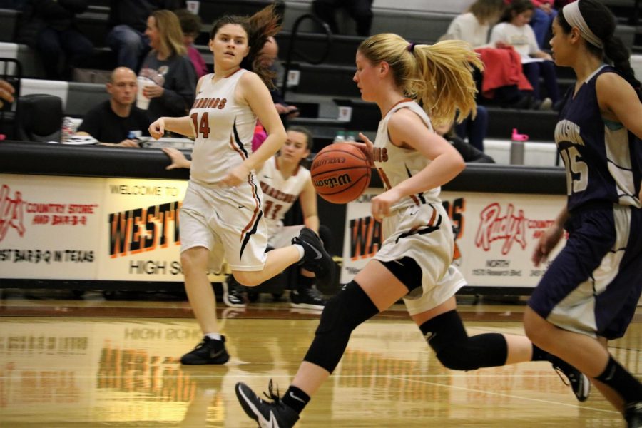 Megan Booknis 20 and Grace Duff 20  run down the court.