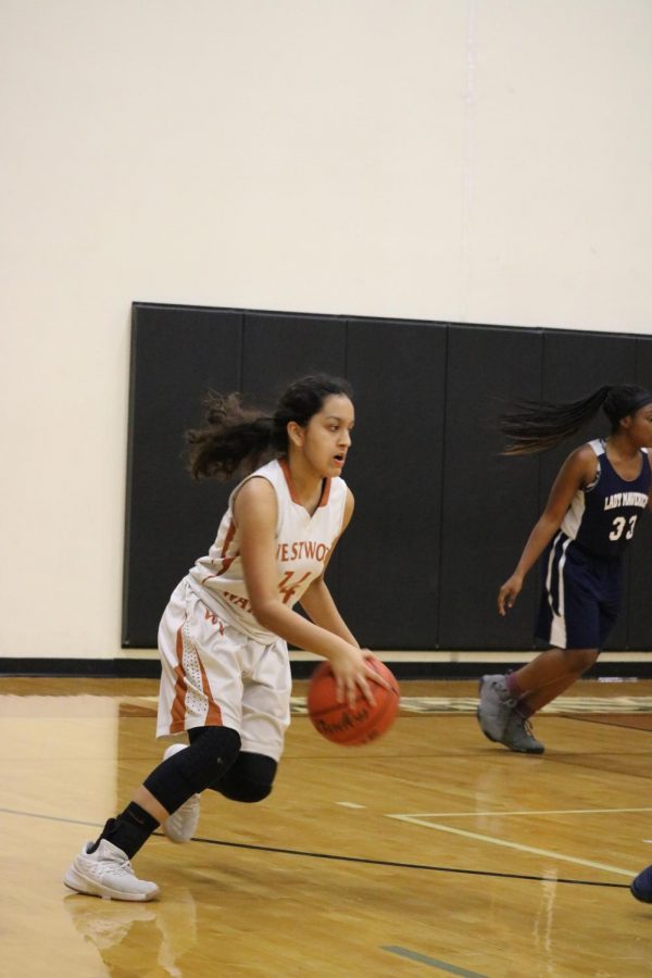 Serena Baruah 21 runs up court with the ball to shoot.