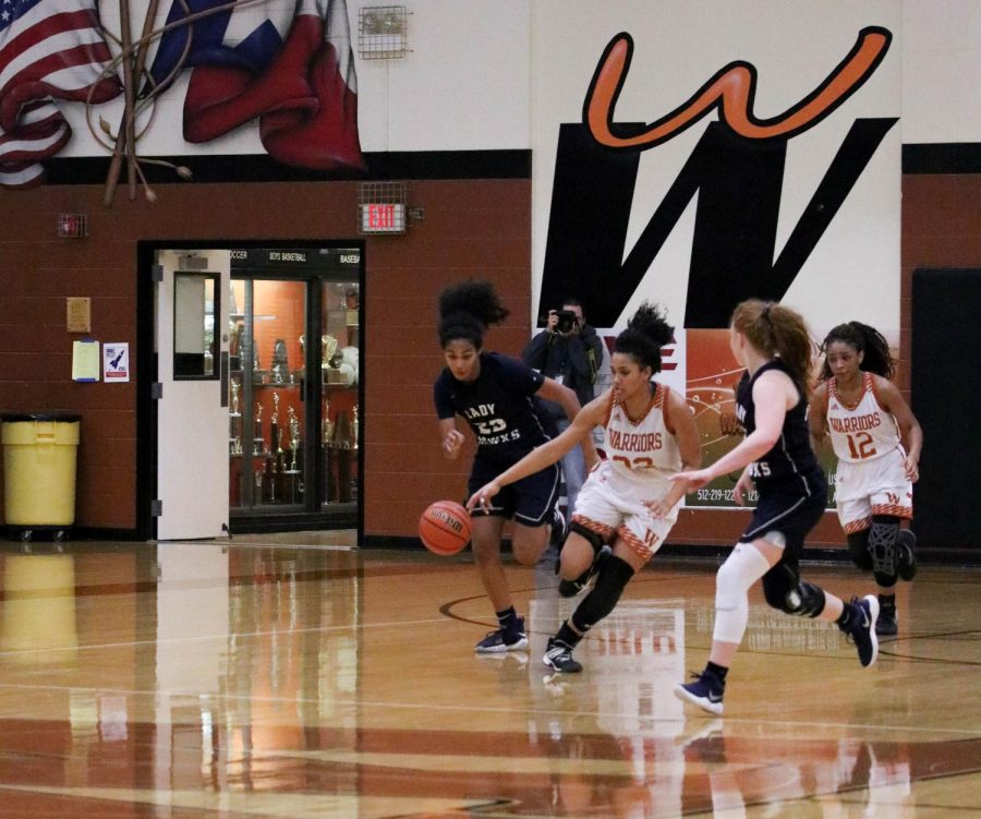 Makayla Coy 19 rushes down the court and passes the Hawks defender. 