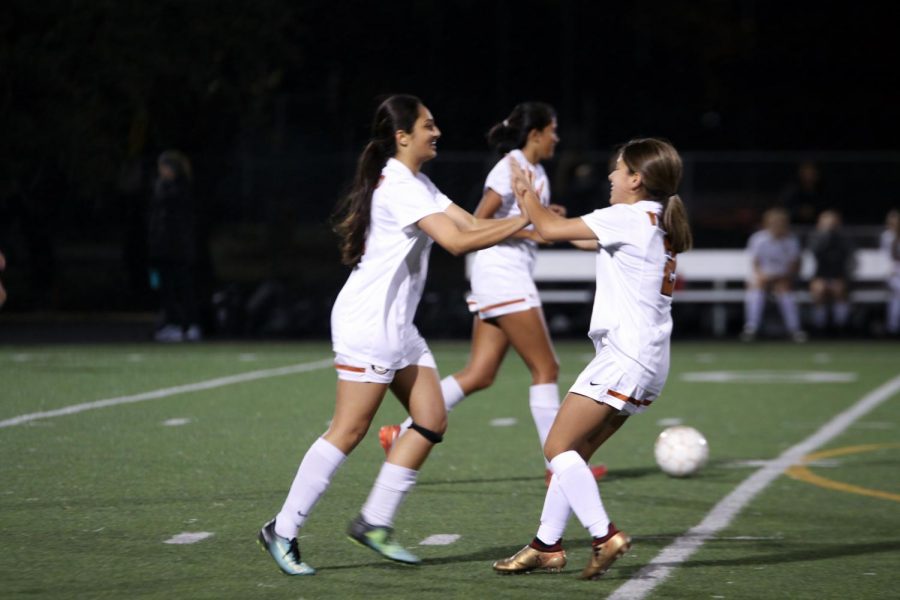 Jaylene Valenzuela 20 runs up to high five Isha Chhabra 20 right after she scores the second goal for the Warriors. 