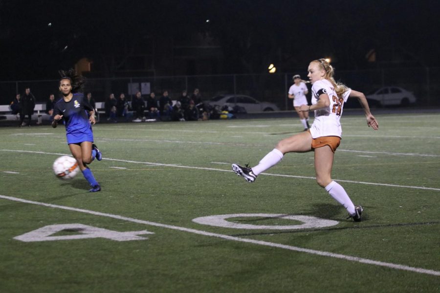 Caroline Gillispie 18 clears the ball up the line to an outside midfielder. 