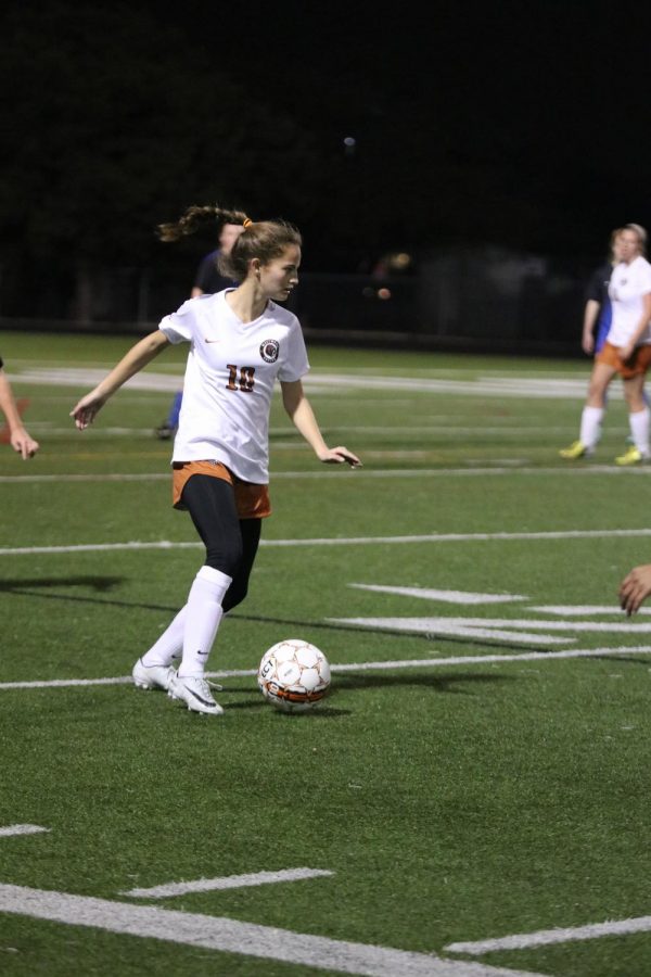Hailey Martinez 21 looks to pass the ball through the middle of the field. 